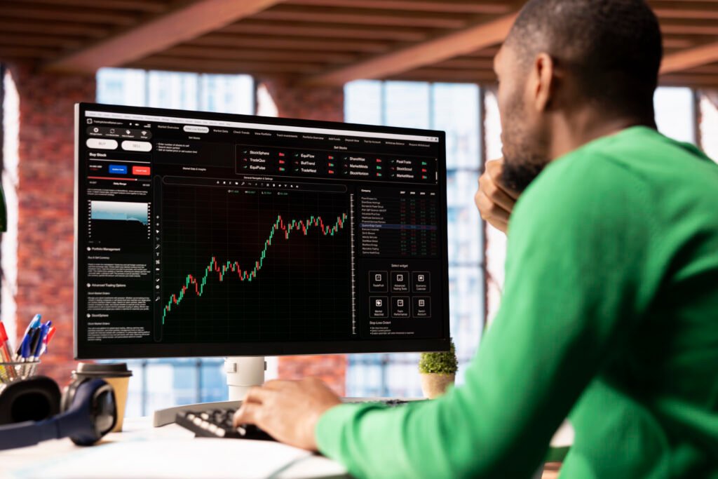 day trader using computer, purchasing stocks that might perform well